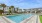 a swimming pool with a building in the background